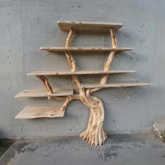 a tree shelf made out of wood on the side of a building