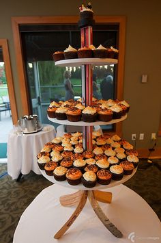 three tiered cupcake display on top of a table