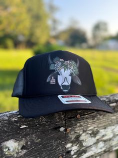 Floral Florida Brahman high crown trucker cap  My name is Hailey. I am a third-generation cattlewoman from central Florida! I created this page to share the pictures I capture while working cattle and every day on the ranch. I am incredibly passionate about the Florida cattle industry and want to share it with everyone! Here's a view of Florida ranch life through my lens! ||SOCIAL MEDIA || Follow all my social media accounts!  Facebook and Instagram: @ranchrevivalphotography Tiktok: @haileytomkow Don't forget to tag me!! Elevate your Western style with this classic Otto trucker hat, designed for those who appreciate both comfort and fashion. Crafted with a breathable mesh back and a sturdy, curved brim, this hat is perfect for long days under the sun. The adjustable snapback closure ensure Black High Crown Hat For Country Events, Western Black Snapback Hat For Rodeo, Black Flat Bill Trucker Hat For Rodeo, Black Snapback Trucker Hat For Rodeo, Black Casual Snapback Hat For Rodeo, Western Style Black Baseball Cap For Outdoor, Black Western Style Baseball Cap For Outdoor, Black Trucker Baseball Cap For Rodeo, Black Baseball Cap For Country Events