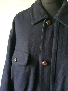 Dark Blue Wool Parka Jacket Long Windbreaker Lightweight Hipster Jacket Hiking Leather Buttons Medium to Large Size Made in Portugal Material: 80% Wool 20% Polyester Lining: 100% Nylon Label size; 52C Measurements (lying flat): Length - 25,5 inch / 65 cm Sleeve - 24.8 inch / 63 cm Shoulders - 21.2 inch / 54 cm Pit to pit - 24,4 inch / 62 cm Hips- 18,1 inch / 46 cm Condition: Good Vintage Condition Please check measurements to insure a proper fit. Remember to allow yourself some extra room for mo Navy Outerwear With Flap Pockets For Work, Navy Button-up Outerwear With Button Cuffs, Navy Button-up Outerwear With Welt Pockets, Classic Navy Outerwear With Flap Pockets, Casual Navy Collared Outerwear, Casual Peacoat With Pockets And Lapel Collar, Navy Single-breasted Long Sleeve Outerwear, Casual Peacoat With Pockets, Casual Pea Coat With Pockets For Outdoors