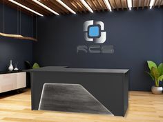 an office with a black desk and blue wall behind the reception counter is a plant