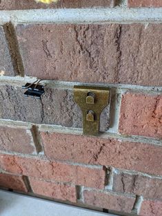 a close up of a brick wall with a lock on it