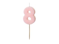 a pink number eight candle on a stick