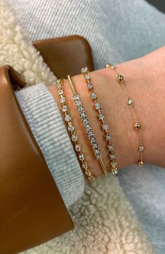 Polished beads and bezel-set diamonds are stationed along this understated bracelet crafted from 14-karat gold. 6 1/2"–6 3/4" adjustable inner circumference Lobster clasp closure Total diamond weight: 0.13ct. Color: G–H Clarity: SI 14k gold/diamond Imported >Diamond Guide Cubic Zirconia Gold Bracelet With Bezel Setting, Bezel Set Diamond Bangle Bracelet, Fine Jewelry With Single Cut Rondelle Diamonds, Adjustable Single Cut Diamond Jewelry, Gold Diamond Rondelle Jewelry, Luxury Rondelle Jewelry With Single Cut Diamonds, Luxury Rondelle Stackable Jewelry, Luxury Diamond Jewelry With Round Beads, Luxury Diamond Round Beads Jewelry