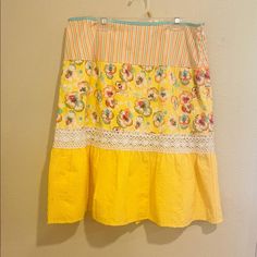 a yellow skirt hanging up against a wall