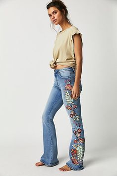 So special in a vintage-inspired design, these classic denim jeans from Driftwood are featured in a high-rise, flare silhouette with exaggerated floral embroidery at sides for added dimension.* Zip-fly and button closure* Five pocket design* Soft, stretch denim Boho Winter Outfits, Boho Jeans, Chic Winter Outfits, Jeans Free People, Winter Boho, All Jeans, Floral Jeans, Embroidery On Clothes, Boho Chic Outfits