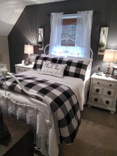 a black and white checkered comforter on a bed in a room with two nightstands