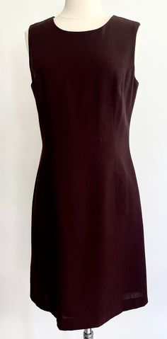 Vintage 90's Henri Bendel New York chocolate brown sleeveless dress with original tags still attached Fully lined and closes with zipper along the back No care label but fabric feels like a light wool blend Marked size 6 and seems to fit in the ballpark of a modern XS/S.  Photographed on a size 2/4 dress form.  Please use measurements to ensure a proper fit. Measurements (zipped & laying flat): Pit-to-pit: 18" Waist: 15-3/4" Hips: 18" Top of shoulder-to-hem: 36-1/4" Good vintage condition.  Please note the Henri Bendel label has a red mark on it - likely because the garment was put on sale.  On the bag of the label, it is written $79 A NOTE ABOUT MY CLOTHING LISTINGS: I'm very picky when it comes to cut and style so you can rest assured my vintage garments will be WEARABLE mixed in with yo Sleeveless Brown Mini Dress For Work, Brown Sleeveless Mini Dress For Work, Formal Brown Fitted Mini Dress, Formal Fitted Brown Mini Dress, Brown Fitted Sleeveless Dress For Work, Fitted Sleeveless Brown Dress, Fitted Sleeveless Brown Dress For Work, Fitted Brown Sleeveless Dress For Work, Elegant Brown Fitted Sleeveless Dress