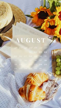 a table topped with croissants and sunflowers next to a book