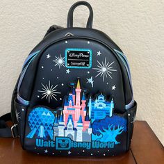 Simulated Leather Mini Backpack Front Zip Pocket With Die-Cut Panel Featuring The Tree Of Life, Spaceship Earth, Hollywood Tower Hotel, And Cinderella Castle ''Walt Disney World'' In Blue Glitter Lettering Front And Sides Feature Silver Screen Art With Tinker Bell And Stars Back Features Mickey Icon Screen Art With Cinderella Castle Iridescent Metallic Blue Simulated Leather Trim Double Zipper Main Compartment Side Slip Pockets Loungefly Logo Metal Pulls Silvertone Hardware Adjustable Straps Wit Disney-styled Black Standard Backpack, Disney Leather Backpack For Disney Trips, Disney Leather School Bags, Disney Leather School Backpack, Disney Leather Backpack For School, Disney Leather Backpack, Black Disney Backpack For Travel, Disney Travel Backpack, Disney Leather Backpack For Everyday Use