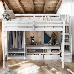 a loft bed with drawers underneath it in a room that has wooden floors and walls