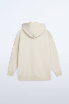 Roomy Sweatshirt With Hooded Mock Neck And Long Sleeves. Hidden In-Seam Chest Pocket. Contrasting Front Printed Text. Ribbed Trim. Casual White Zara Sweatshirt, White Crew Neck Sweatshirt By Zara, White Cotton Zara Sweatshirt, Zara Casual Cotton Sweatshirt, White Zara Crew Neck Sweatshirt, Zara White Crew Neck Sweatshirt, Zara Oversized Cotton Sweatshirt, Oversized Zara Cream Tops, Oversized Cream Zara Tops