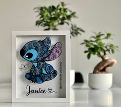 a paper cut out of a blue and purple cartoon character with the name janice on it