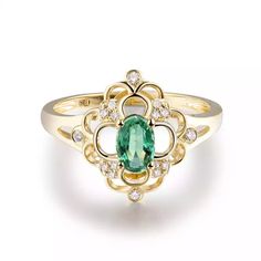 a ring with an oval green stone surrounded by small white and yellow diamonds on it