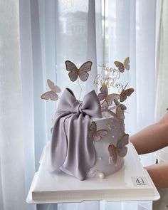 a birthday cake with butterflies on it