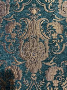 a blue and gold fabric with an intricate design