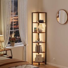 a bed room with a neatly made bed and a book shelf next to a window