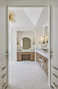 a large bathroom with two sinks and mirrors