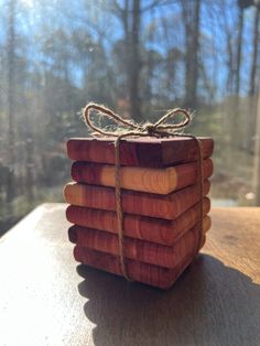 a stack of wooden blocks tied with twine and sitting on top of a table