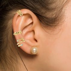 A striking blend of modern edge and timeless craftsmanship, this edgy ear cuff adds a touch of oomph with its modern SPIKE design. Perfect for layering or wearing solo, it’s a versatile statement piece fthat requires no piercings. Made from premium 14K Solid Gold, this ear cuff is designed for comfort and style, offering a seamless way to elevate any look, from day to night. This earrings was handcrafted in New York City and we are proud to say that we support women-owned businesses / artisans  The Price is for ONE Piece (not a pair) Care and Cleaning. Warm, soapy water is always safe. Packaged with a velvet pouch and gift box Spike Ear Cuff, Curated Ear, Award Winning Jewelry, Support Women, Gold Ear Cuff, Ear Stack, Versatile Jewelry, Forever Jewelry, Spiral Earrings