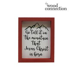 a wooden frame with the words, go tell it on the mountain that jesus christ is born