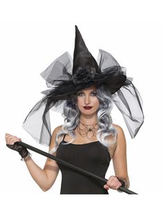 a woman wearing a witches hat and holding a wand