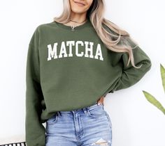 Matcha Sweatshirt Collegiate Crewneck Sweater Unisex, Matcha Latte Club Iced Coffee Sweatshirt Gift Gildan Tee Retail fit 5.3 oz/yd², 100% Cotton Preshrunk jersey knit Seamless double-needle 7/8″ collar Taped neck and shoulders Tear away label Double-needle sleeve and bottom hems Quarter-turned to eliminate center crease Fiber content varies by color, see color list for exceptions Item Details: - Unisex fit perfect for both men and women - Tees are standard sizes so we suggest ordering your usua Women Tees, Coffee Sweatshirt, Custom Printed Shirts, Matcha Latte, Crewneck Sweater, Iced Coffee, Crew Neck Sweater, Matcha, Knit Jersey