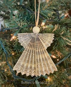 an ornament hanging from a christmas tree with music notes on it's wings