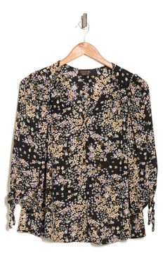 Dainty flowers bloom across a tie-sleeve top in a breezy silhouette. 25" length (size S) V-neck Three-quarter sleeves Slips on over head 100% polyester Machine wash, line dry Made in the USA of imported fabric Model Stats: 5'10" height; 34" bust; 27" waist; 35" hips. Model is wearing size S. Spring Floral Print V-neck Blouse, Floral Print 3/4 Sleeve Work Blouse, Floral Print 3/4 Sleeve Workwear Blouse, Spring Puff Sleeve Blouse With Tie Sleeves, Printed 3/4 Sleeve Blouse For Fall, Floral Print Workwear Blouse With 3/4 Sleeves, Ditsy Floral Print V-neck Blouse For Fall, V-neck Ditsy Floral Print Blouse For Fall, Fall V-neck Blouse With Ditsy Floral Print