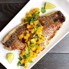 fish with mango salsa on a white plate