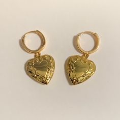 Introducing our Sylvia Locket Earring. The Sylvia locket earring is made of 16mm gold plated hoop with 18k gold plated heart shaped locket (20mm x 20mm) find us on - depop: @milanajewelry instagram: @milanaajewelry (usa shop) @milanajewelryaz (european shop)  tiktok: @milanajewelry Gold Tarnish-resistant Huggie Earrings As A Gift, Gold Tarnish Resistant Huggie Earrings As Gift, Gold Tarnish Resistant Huggie Earrings For Gift, Silver Gold-plated Heart Earrings For Gifts, Gold Plated Heart Pendant Earrings As Gift, Gold Heart-shaped Earrings As Gift For Her, Gold Plated Heart Pendant Earrings For Gift, Gold Heart Earrings As A Gift For Her, Gift Silver Gold Plated Heart Earrings