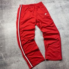 Add some vintage style to your workout with these red Nike sweatpants from the 00s. Made with comfortable cotton and an elastic waist, these pants are perfect for running, basketball, or hitting the gym. With a geometric pattern and classic Nike logo, these pants are a must-have for any sports lover. #VintageSportswear #NikeSweatpants #RedPants #Activewear #Throwback #MensFashion  #eBay #eBayStore #eBaySeller #Nike #Cotton #Activewear #Pants #Regular #Men #XL #Red #Basketball #Indonesia Red Nike Sweatpants, Vintage Nike Pants, Red Sweatpants, Pants Outfit Men, Vintage Sportswear, Sweatpants Outfit, Nike Sweatpants, Red Nike, Sports Lover