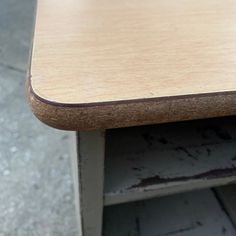 a close up view of a wooden table with no one sitting at the top or standing on it