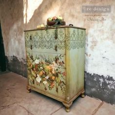 an old dresser with flowers painted on it