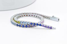 Here we have a beautiful multi-color simulated sapphire tennis bracelet. All round cut gemstones are prong set. This dainty, elegant and beautiful bracelet has approximately 2 cts of weight of gemstones. Each stone is about 2mm in size. This beautiful tennis bracelet was designed to allure and impress. It will be an excellent addition to a jewelry collection due to its uniqueness. Handmade item with unique heavy duty clasp. The bracelet is made out of solid 925 Sterling Silver with platinum over Anniversary Multi-stone Cubic Zirconia Tennis Bracelet, Multicolor Cubic Zirconia Tennis Bracelet For Anniversary, Multicolor Gemstone Tennis Bracelet, Sapphire Tennis Bracelet, Tennis Bracelet, Chain Link Bracelet, Beautiful Bracelet, Solid 925 Sterling Silver, Sterling Silver Bracelets