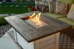 a fire pit sitting on top of a wooden table