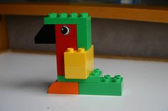 a lego bird is sitting on the table