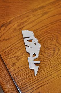 a close up of a wooden table with metal letters on it