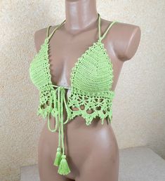 Embrace the bohemian spirit with our enchanting Light Green Crochet Bikini Top . This intricately crafted piece exudes Boho charm with its open-back design, showcasing the artistry of crochet in a stylish and playful manner. The backless crochet tank top not only adds a touch of allure but also radiates a free-spirited vibe perfect for festival fashion. Elevate your summer wardrobe with this unique and versatile Boho top that effortlessly blends comfort and style, making it an essential addition Hippie Sleeveless Crochet Top For Beach, Bohemian Crochet Lace Halter Top For Beach, Beach Party Crochet Lace Top, Bohemian Crochet Lace Halter Top For Vacation, Bohemian Crochet Halter Neck Top For Festivals, Handmade Crochet Beachwear Top For Beach Cover-up, Handmade Crochet Beachwear Top, Handmade Crochet Beach Cover-up Top, Beachwear Festival Halter Top With Crochet Trim