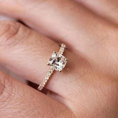 a woman's hand with a diamond ring on it