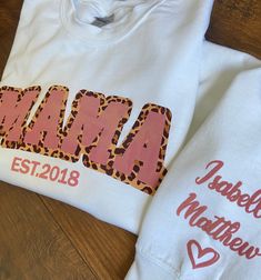 two personalized t - shirts with the word mama and leopard print are on a wooden table