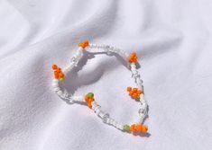 cute 90s aesthetic carrot chain bracelet ♡  elastic bracelet orange, green, & white beads Trendy Orange Jewelry For Spring, Cute Orange Jewelry With Colorful Beads, Casual Orange Jewelry For Spring, Casual Orange Spring Jewelry, Spring White Beaded Bracelets With Letter Beads, Handmade Orange Bracelet For Spring, Daisy Chain Bracelet, 90s Aesthetic, Daisy Chain