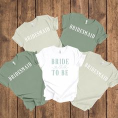 four bridesmaid shirts on top of a wooden table with the words, i bridal to be