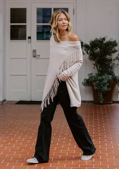 Our best-selling, classic fringed sweater in a super soft, pointelle knit. With inner and outer buttons, this bohemian lightweight sweater can be worn closed or open like a cardigan. FINAL SALE Pointelle knit Easy, relaxed fit Long sleeves Hip length Cowl neckline Inner & outer buttons to secure draped silhouette Can be worn as an open cardigan or buttoned up Model is 5'9, wearing a size S.Style: IMP-5797PIQ-NW Light Cardigan, Fringe Sweater, Pointelle Knit, Wrap Sweater, Lightweight Sweater, Easy Knitting, Open Cardigan, Winter White, Light Weight Sweater