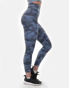 a woman in grey camo print leggings with her hands on her hips