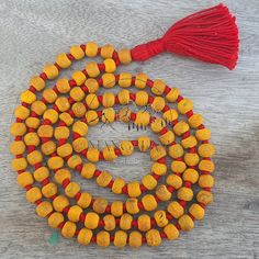 📿This Mala is handcrafted with Turmeric Beads. Turmeric is much revered by Hindus and is considered one of the most purifying herbs in Ayurveda. Each Bead is mindfully knotted with love, one at a time on a durable nylon silk chord for extra strength, to extend their lives & is finished with a Silk Tassel adorned with silver Zari. Historically, the tassel has worked as a talisman and is used as a sign of power, prestige, protection, and spiritual significance . One who wears / keeps Turmeric mala also acquires a good amount of spiritual powers.📿 📕 MATERIALS 📕 🦉Turmeric Beads 🦉Nylon Silk Cord 🦉Silk Tassels 🦉Silver Zari 📕 PRODUCT DIMENSIONS 📕 📏Mala Necklace Length: 41-43 inches approx 📏Tassel Length: 3.5 - 4.0 inches approx 📏Shape : Round 📏Size : 8 MM 📏Number Of Beads: 108 Mala Traditional Handmade Beaded Bracelets For Meditation, Bohemian Beaded Bracelets For Puja, Bohemian Necklaces With Wooden Beads For Puja, Artisan Beaded Mala For Meditation, Handmade Spiritual Mala With Oval Beads, Handmade Multicolor Spiritual Mala, Handmade Red Mala For Healing, Multicolor Handmade Spiritual Mala, 8mm Amber Beads For Spiritual Use