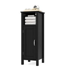 a black cabinet with white towels on it