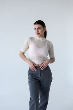 Light mohair knitted crop sweater a stylish addition to your look! Elevate your summer wardrobe with our Light Mohair Knit Top. Crafted with a luxurious mohair, this T-shirt exudes refined elegance and breezy comfort.  Very light, transparent and tender wool pullover. Material: 70% super kid mohair, 30% polyamide.  The color of the top is white natural, not bleached. Please note, due to difference in monitors and brightness level, colours may slightly vary. Super kid mohair is a natural material, it is a yarn made from the hair of the Angora goat. If you have very sensitive skin, you can feel the discomfort from contacting the yarn with the skin. In this case, we advise wearing mohair's things over a shirt or blouse. If you want to make a personal order, you can request the desired color. Chic Crew Neck Cropped Sweater For Summer, Fitted Crew Neck Cropped Sweater For Summer, Chic Open Knit Cropped Sweater For Summer, Mohair Tops For Fall, Chic Fitted Open Knit Cropped Sweater, Casual Mohair Crew Neck Top, Winter Fine Knit Mohair Tops, White Mohair Knitted Sweater, Fine Knit Mohair Tops