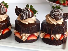 three chocolate cakes with strawberries on top