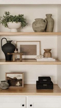 a shelf with vases and other items on it